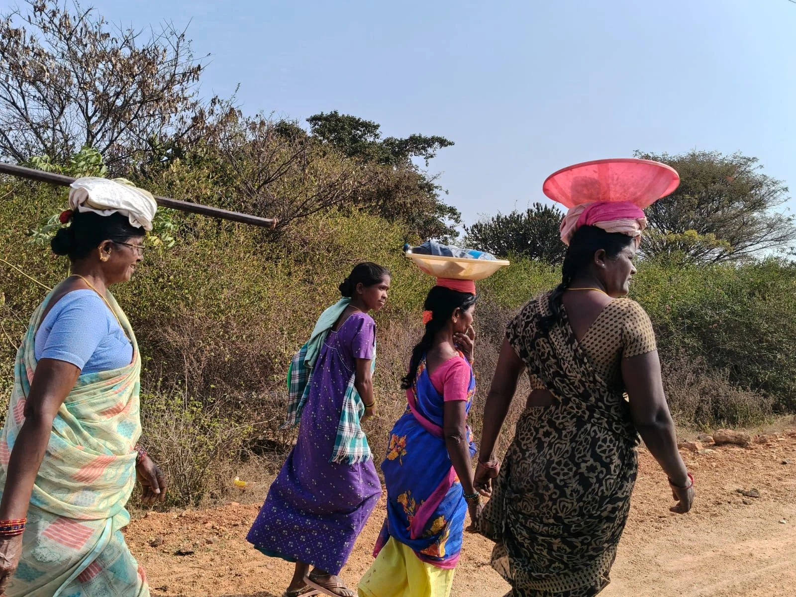 People walking together beside the river.