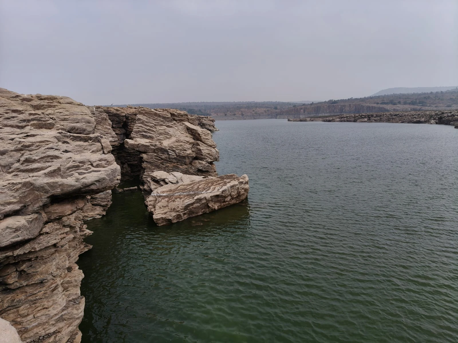 Layered rock ledges above the river.
